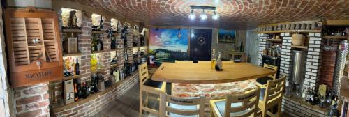 a room with a table and some bottles of wine at Guest House Milicevic in Ljubuški