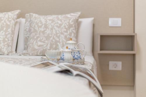 a bed with a book and a tea set on it at Puerto Playa 3 in Puerto del Rosario