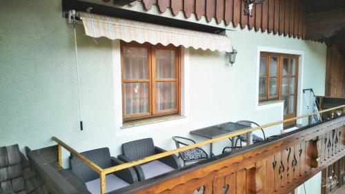 a group of chairs on the balcony of a building at Familienappartement Seppenbauer in Bad Ischl