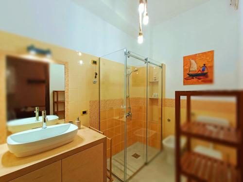 a bathroom with a sink and a glass shower at Terrammare del Golfo in Castellammare del Golfo