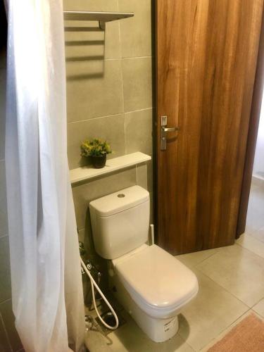 a bathroom with a toilet and a wooden door at Chalet ground floor 3BR amwaj sidi abdelrahman in El Alamein