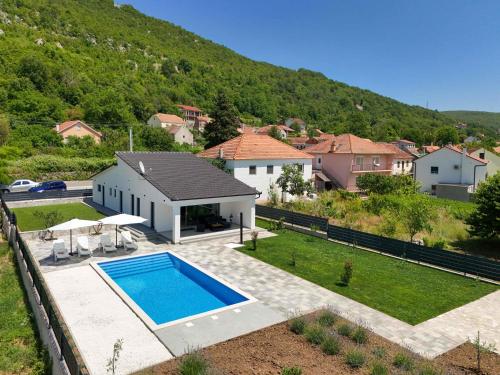 a house with a swimming pool in a yard at Kuća Grab in Grab