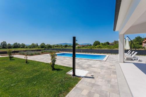 a swimming pool in the backyard of a house at Kuća Grab in Grab
