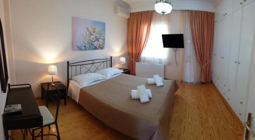 a bedroom with a bed with two towels on it at House of Aggelos - Karya Lefkadas in Kariá
