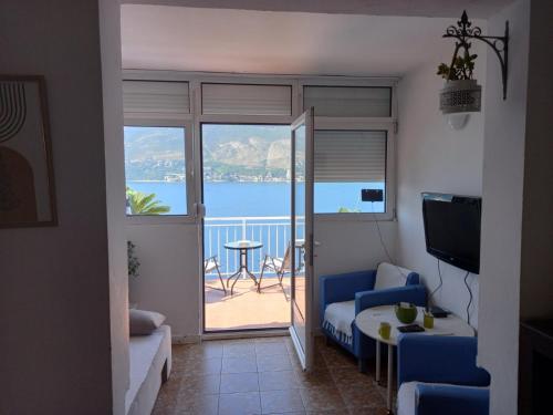 a living room with a view of the water at Bay View Apartment in Herceg-Novi