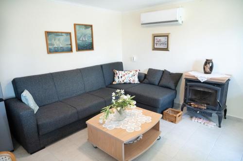 a living room with a couch and a fireplace at Panoramic Escape - Thesprotiko in Thesprotiko