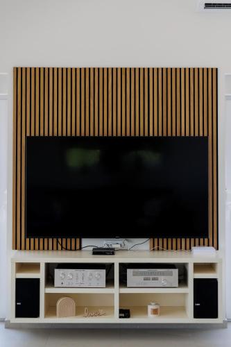 a flat screen tv sitting on a entertainment center at Kuća Grab in Grab