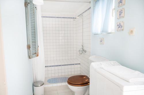 a white bathroom with a toilet and a sink at Panoramic Escape - Thesprotiko in Thesprotiko