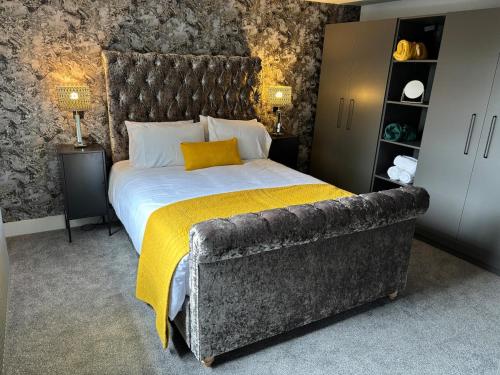 a bedroom with a large bed and a couch at Boutique 2 bedroom apartment in Mersham