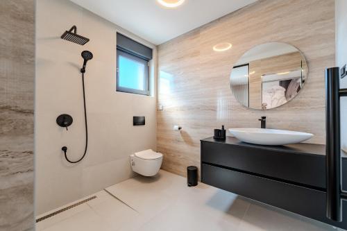 un baño con lavabo y espejo en Villa Ballat, en Privlaka