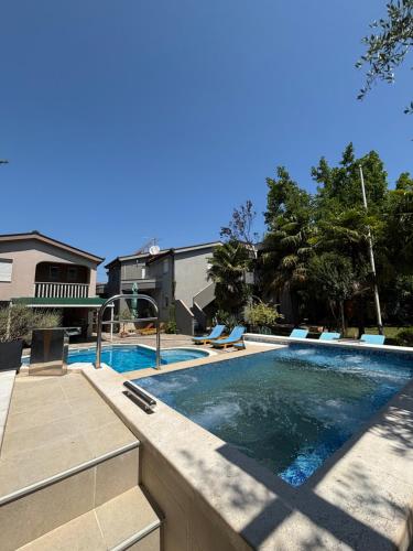 a swimming pool in a yard with a swimming pool at Holiday home Milicevic in Ljubuški