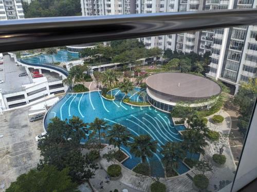 an overhead view of a large swimming pool in a city at Santaii Putrajaya #6pax Pool View in Putrajaya
