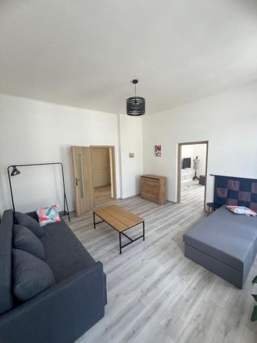 a living room with a couch and a coffee table at Apartmány LISTOPAD 17 in Děčín