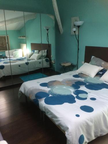 a bedroom with a bed and a mirror at du coté de chez soi in Loupian