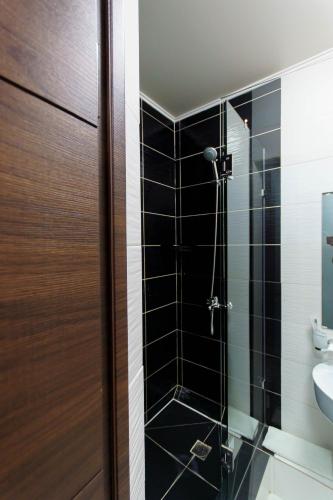 a bathroom with a shower with a glass door at Premier Inn Astana in Astana