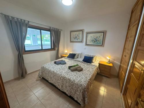 a bedroom with a bed with two pillows on it at Atlantic View Tenerife South in Arona