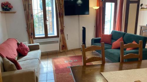 a living room with a couch and chairs and a table at Mountain View - de Maison en Maison in Sorède