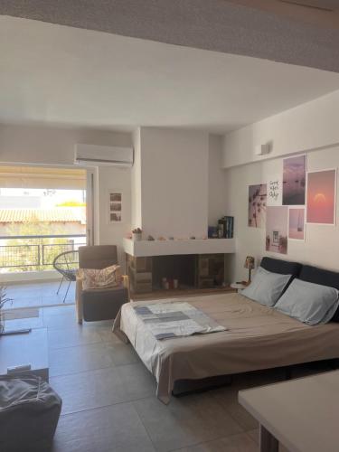 a bedroom with a bed in a room with a fireplace at Sparkling dream in Saronida