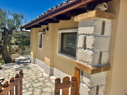 a house with a window on the side of it at "The Cottage"with sea view, parking & wifi in Avola