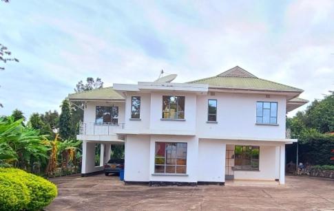 a large white house with a driveway at Misenani House njiro in Arusha