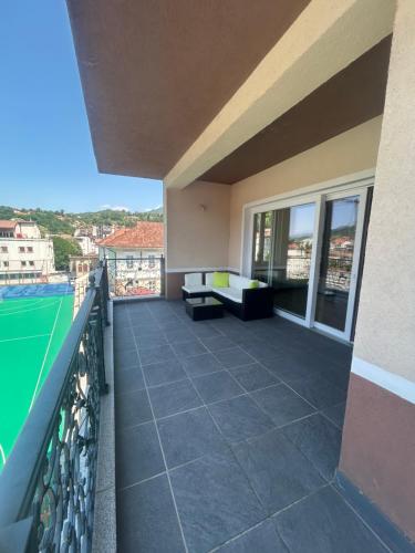 a balcony of a building with a view of a tennis court at Apartmani prenj 1 i 2 centar in Konjic