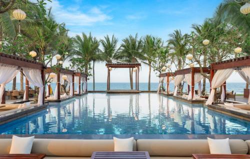 a swimming pool with a view of the ocean at Naman Retreat in Da Nang