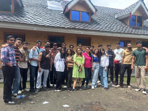 a group of people standing in front of a house at Apple Land by Naavagat in Jibhi