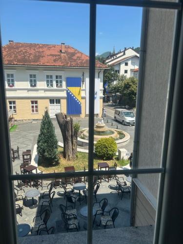 a view from a window of a patio with tables and chairs at Apartmani prenj 1 i 2 centar in Konjic