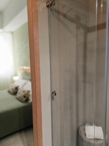 a bathroom with a glass door with a bed at Terrammare del Golfo in Castellammare del Golfo
