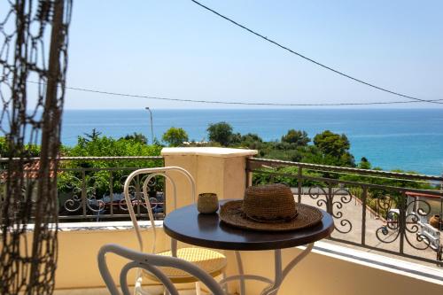a hat sitting on a table on a balcony at Hotel Agios Thomas in Ligia