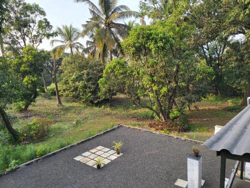 a patio with two plants on top at Bombay High Retreat in Parhūr