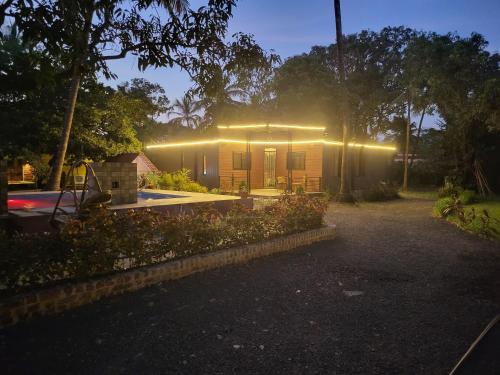 a house with lights on the front of it at Bombay High Retreat in Parhūr