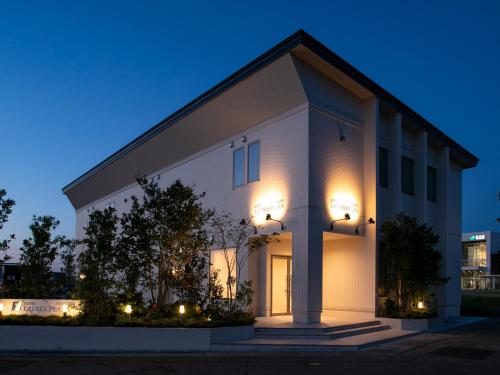 a white building with lights on it at night at HOTEL LADIES PLAZA YOKOTE -female only- in Yokote
