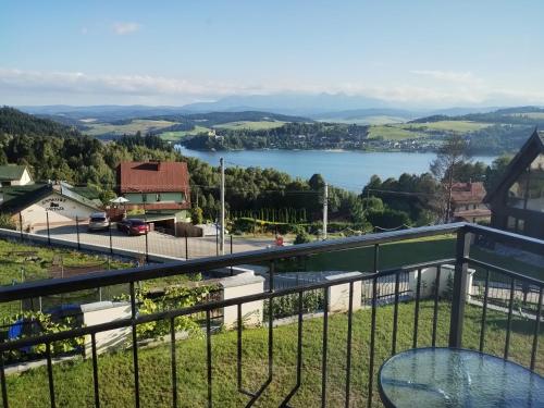 a view of a lake from a balcony at Widokowy Zakątek in Czorsztyn