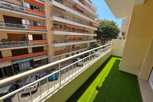 an apartment building with a balcony with green grass at Antibes hyper center - 4 people - close to shops and beaches in Antibes