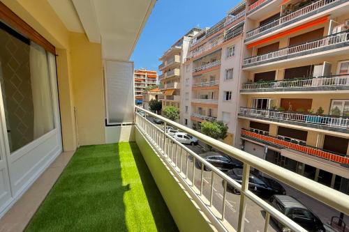 a balcony with green grass in a building at Antibes hyper center - 4 people - close to shops and beaches in Antibes