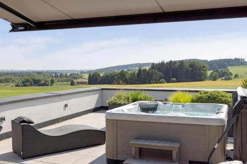 a hot tub on the balcony of a house at Chalet Am Ried in Bad Wurzach