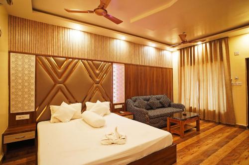 a hotel room with a bed and a chair at Holiday Beach Resort !! Beach Distance 50 Mts !! in Mandarmoni