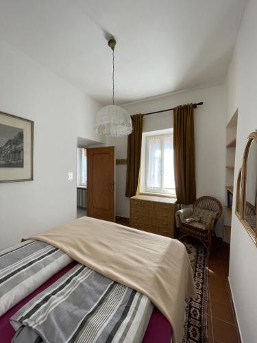 a bedroom with a large bed and a chandelier at Casa Borgo in Montasola