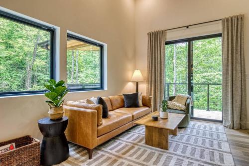 a living room with a couch and a table at Peaceful Smoky Treehouse| Hot Tub • Hammock • Deck in Line Spring