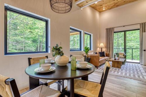 a living room with a table and chairs at Peaceful Smoky Treehouse| Hot Tub • Hammock • Deck in Line Spring
