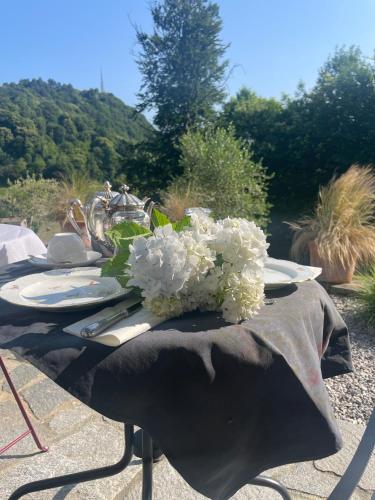 a table with a centerpiece of white flowers on it at The Iconic Lodge in Bellagio