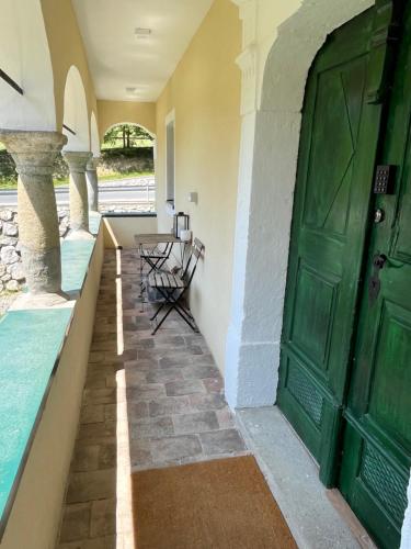 a green door of a building with a table and chairs at Golavškov mlin in Prebold