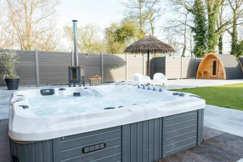 a jacuzzi tub in a yard with a backyard at Wellness aan de Vecht - 1e verdieping by Droomvilla in Dalfsen