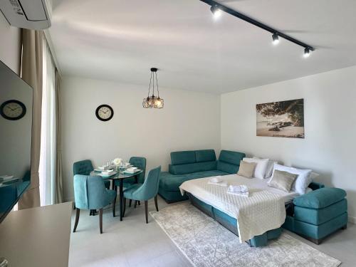 a living room with a couch and a table at Isidora Seafront Apartments in Igalo