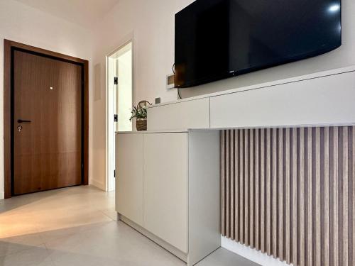 a living room with a flat screen tv on a wall at Isidora Seafront Apartments in Igalo