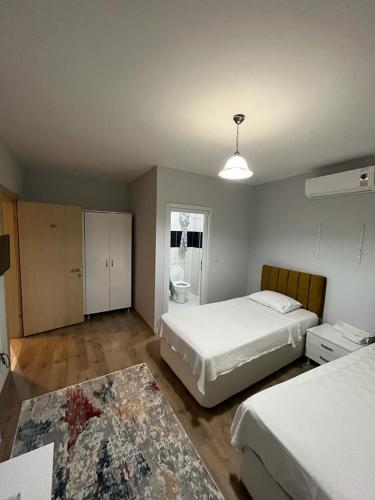 a bedroom with two beds and a bathroom at Elit 61 Hotel in Trabzon