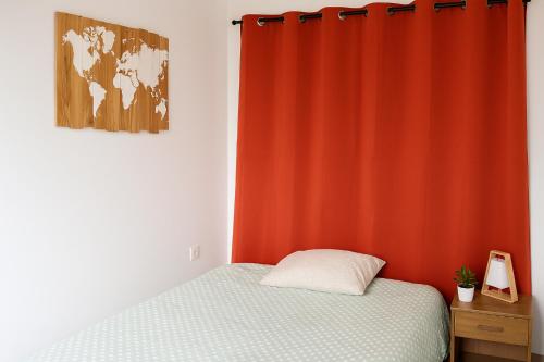 une chambre avec un lit et un rideau rouge dans l'établissement Cannes Casa Pierra Apartment, à Cannes