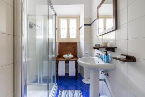 łazienka z umywalką i przeszkloną kabiną prysznicową w obiekcie Antica Casa Balsari w mieście Borgo Ticino