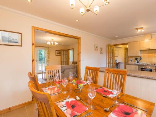 a dining room with a table with wine glasses at Broombank Cottage in Inverness